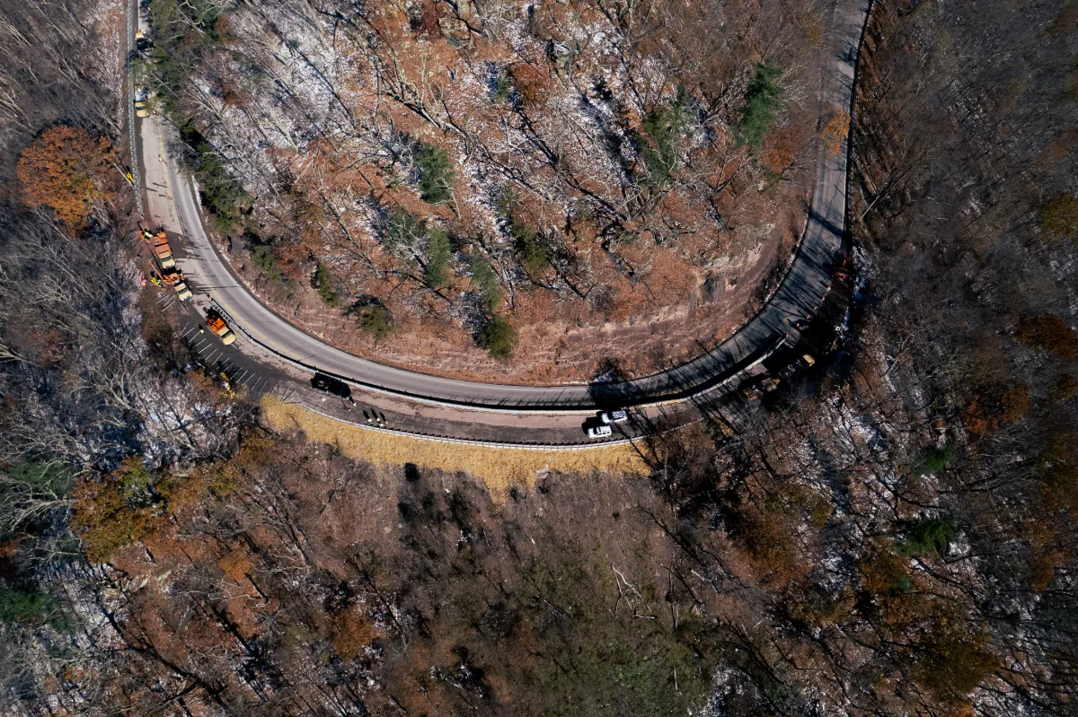 Overhead aerial view of the Guardian 5 MASH TL-5 steel barrier lining a mountain curve for heavy truck containment