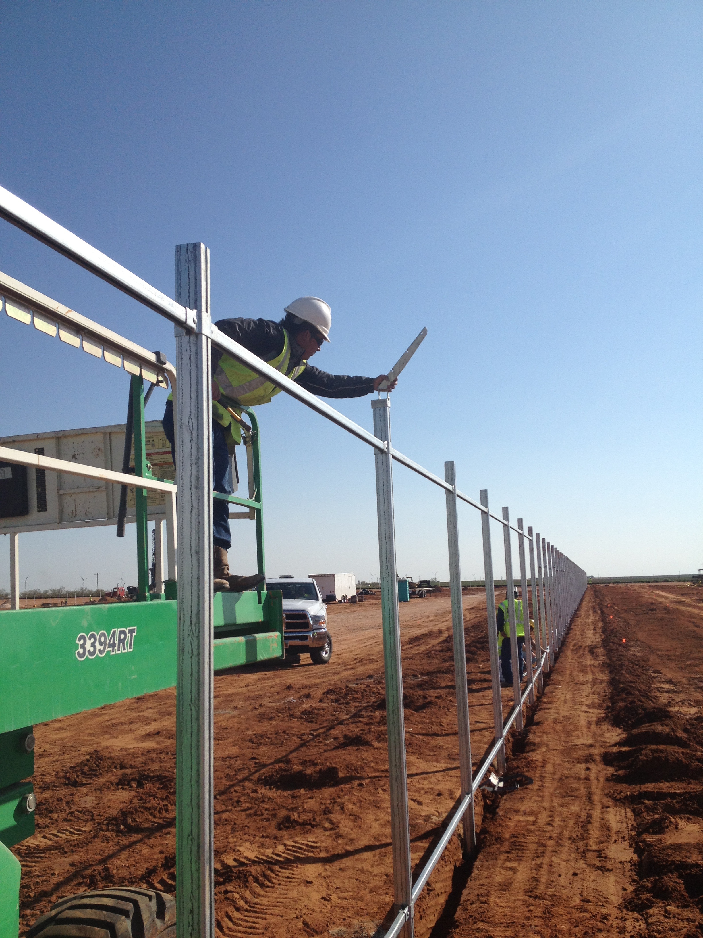Installing barbed wire arms