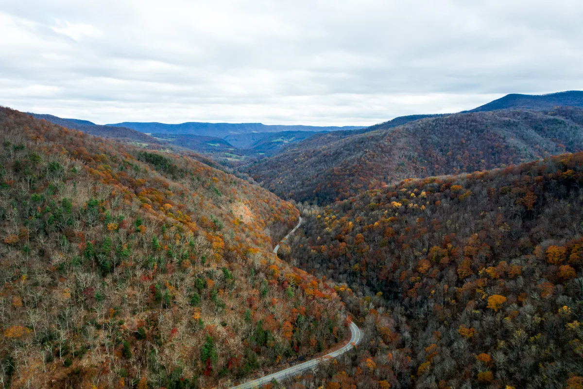 Aerial view of a West Virginia mountain corridor with steep grades and heavy commercial truck traffic